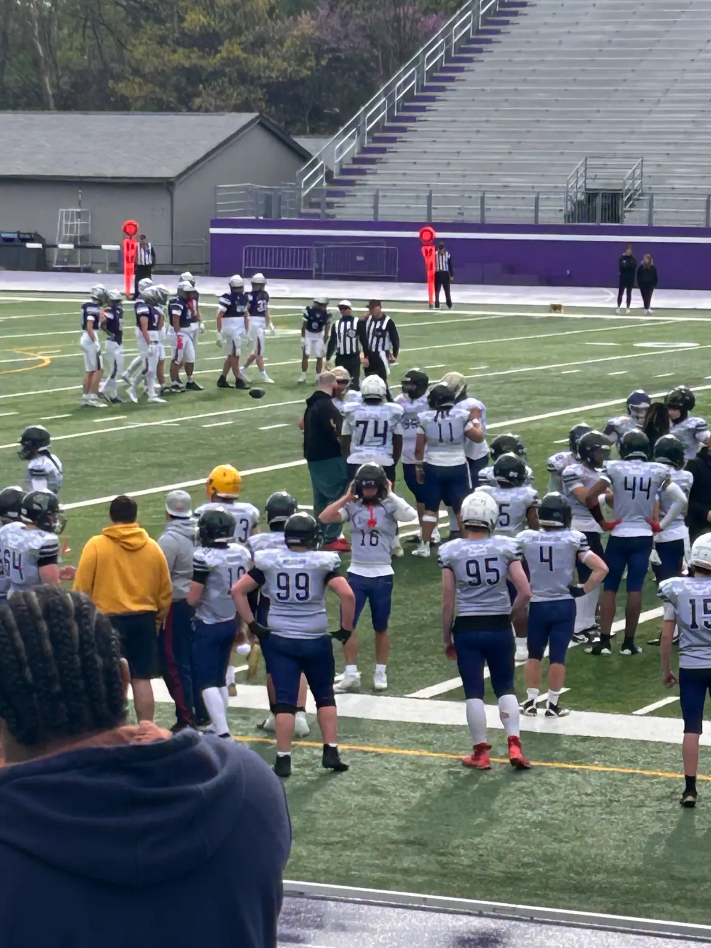 Sentinels athletes huddle together on the field